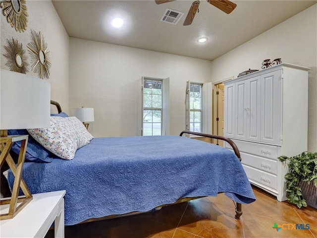 tiled bedroom with ceiling fan