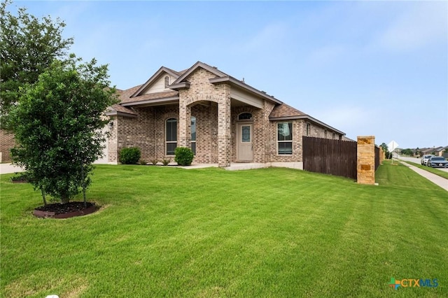 view of front of home with brick siding and a shingled roof