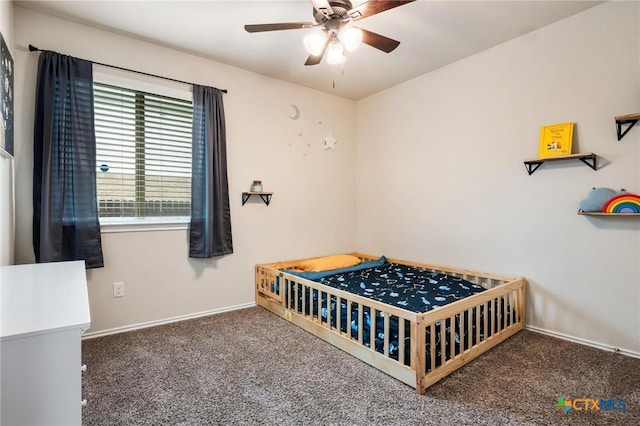 carpeted bedroom featuring baseboards and ceiling fan