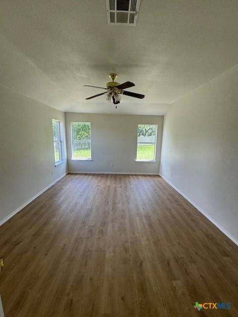 500 Chickasaw Dr, Harker Heights, TX 76548 - unfurnished room featuring dark wood finished floors, healthy amount of natural light, and ceiling fan
