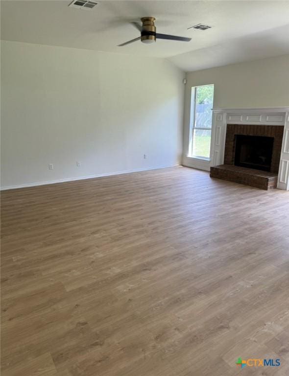 500 Chickasaw Dr, Harker Heights, TX 76548 - unfurnished living room with wood finished floors, a ceiling fan, and a brick fireplace