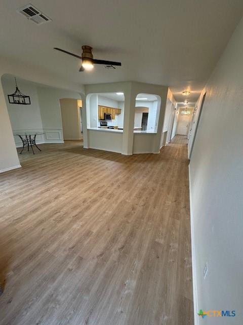 500 Chickasaw Dr, Harker Heights, TX 76548 - unfurnished living room with wood finished floors, ceiling fan, and arched walkways