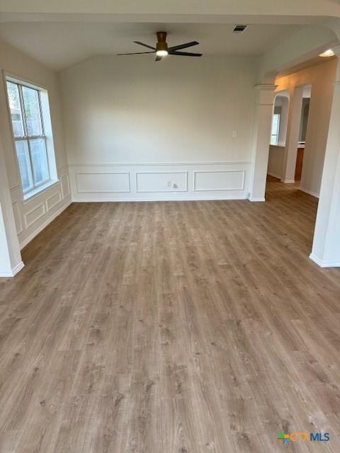 500 Chickasaw Dr, Harker Heights, TX 76548 - empty room featuring a decorative wall, arched walkways, vaulted ceiling, wood finished floors, and ceiling fan