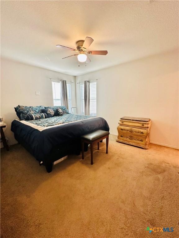 carpeted bedroom featuring ceiling fan