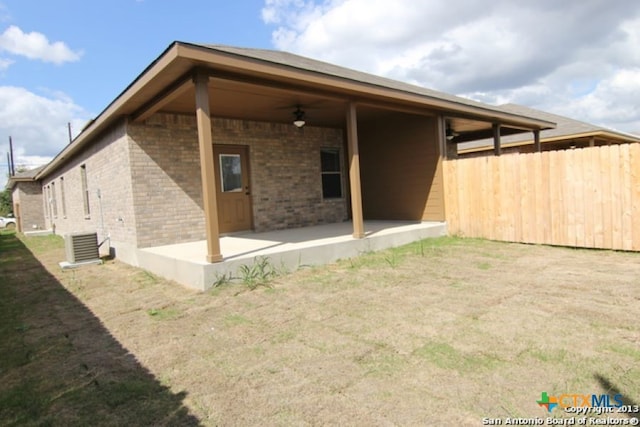 260-262 Rosalie Dr, New Braunfels, TX 78130 - rear view of house featuring cooling unit, a ceiling fan, a patio area, brick siding, and fence