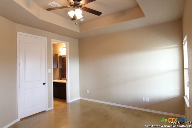 260-262 Rosalie Dr, New Braunfels, TX 78130 - unfurnished bedroom featuring a raised ceiling, baseboards, visible vents, and connected bathroom