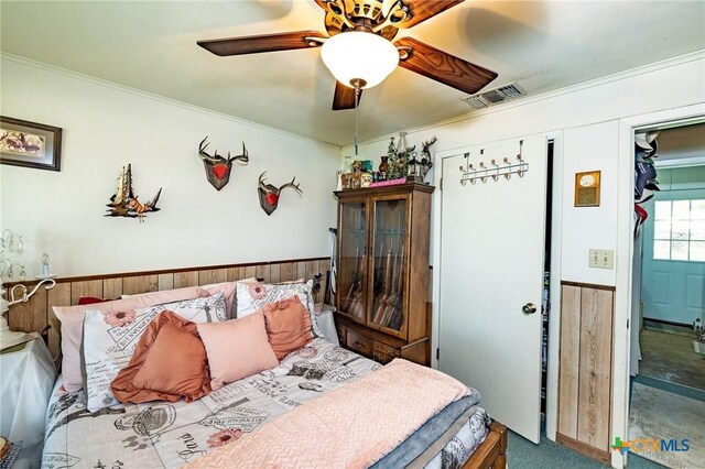 1429 Gardien St, Gonzales, TX 78629 - bedroom featuring visible vents, ornamental molding, ceiling fan, and carpet floors