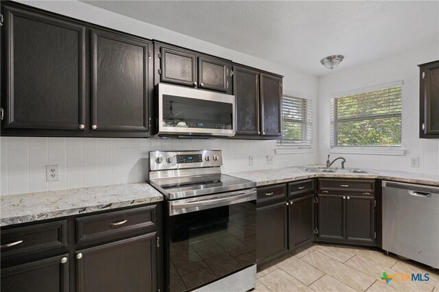 4401 Maggie Dr, Killeen, TX 76549 - kitchen with stainless steel appliances, a sink, decorative backsplash, and light tile patterned floors