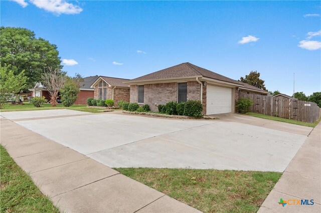 4401 Maggie Dr, Killeen, TX 76549 - single story home with brick siding, driveway, an attached garage, and roof with shingles