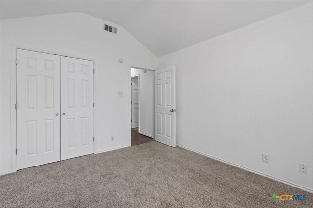 4401 Maggie Dr, Killeen, TX 76549 - unfurnished bedroom with carpet floors, lofted ceiling, a closet, and baseboards