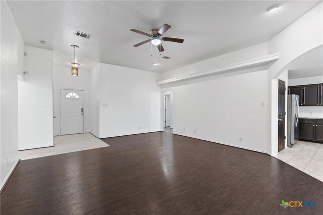 4401 Maggie Dr, Killeen, TX 76549 - unfurnished living room featuring a ceiling fan, light wood-type flooring, and arched walkways