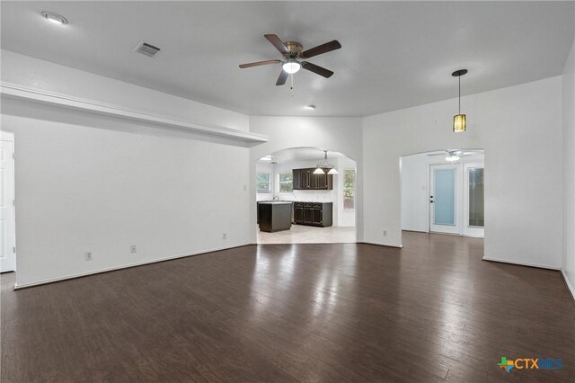 4401 Maggie Dr, Killeen, TX 76549 - unfurnished living room with a ceiling fan, arched walkways, and wood finished floors