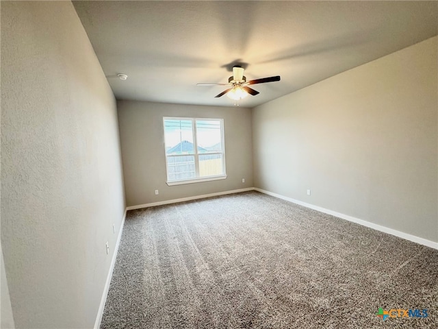 empty room with carpet floors and ceiling fan