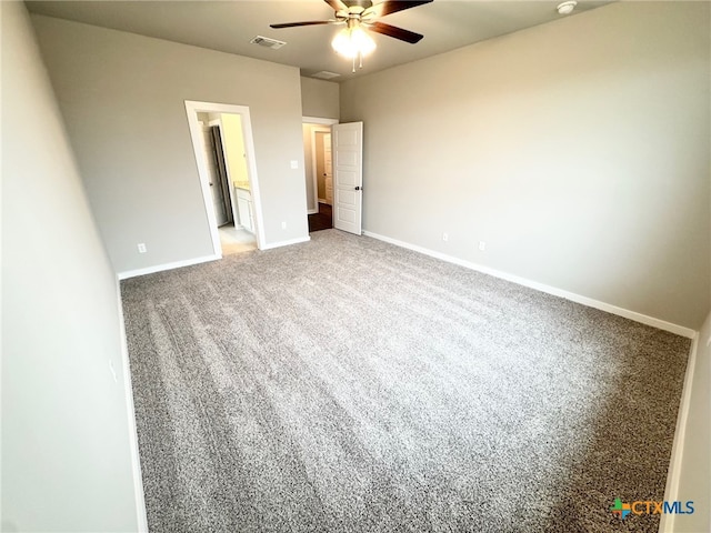 unfurnished bedroom with carpet, connected bathroom, and ceiling fan