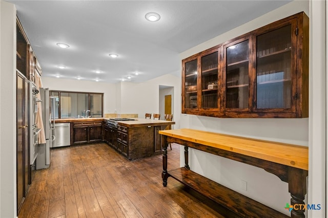 105 Creekside Dr, Victoria, TX 77904 - kitchen featuring stainless steel appliances, dark wood finished floors, dark brown cabinetry, light countertops, and recessed lighting