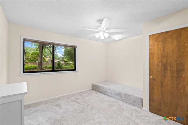 105 Creekside Dr, Victoria, TX 77904 - unfurnished bedroom with carpet flooring, a textured ceiling, and ceiling fan
