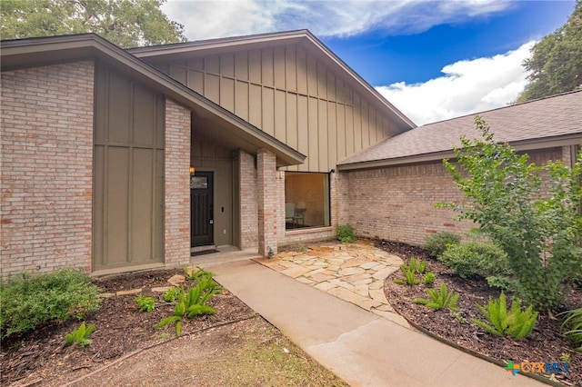 105 Creekside Dr, Victoria, TX 77904 - doorway to property with board and batten siding and brick siding
