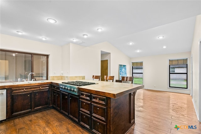 105 Creekside Dr, Victoria, TX 77904 - kitchen with stainless steel gas cooktop, dark wood finished floors, dark brown cabinets, dishwasher, and vaulted ceiling