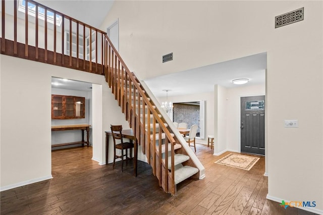 105 Creekside Dr, Victoria, TX 77904 - staircase with wood-type flooring, a chandelier, and a towering ceiling