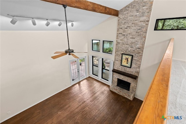 105 Creekside Dr, Victoria, TX 77904 - unfurnished living room with hardwood / wood-style floors, high vaulted ceiling, rail lighting, a fireplace, and a ceiling fan