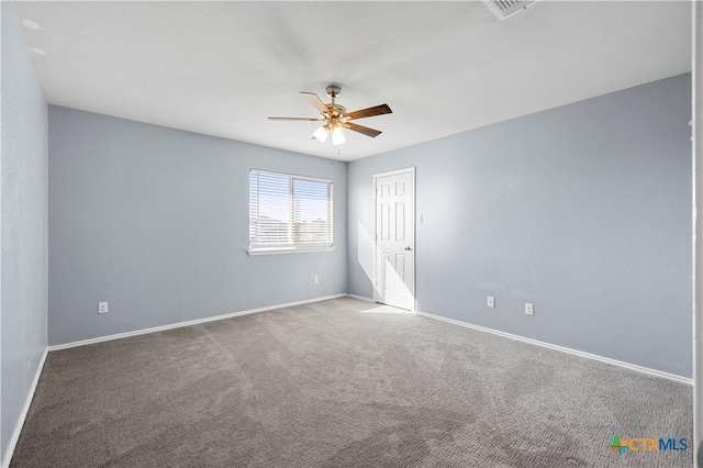 spare room with visible vents, carpet, a ceiling fan, and baseboards