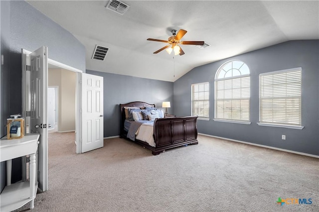 bedroom with lofted ceiling, visible vents, and baseboards