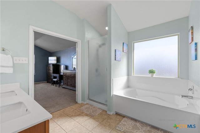 full bath featuring double vanity, a garden tub, a shower stall, and tile patterned floors