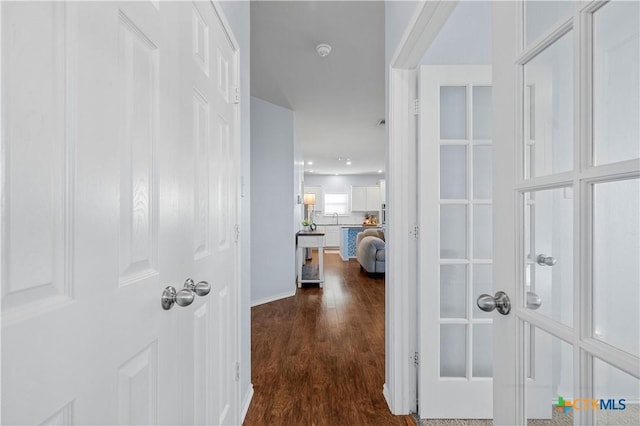 corridor with dark wood-style floors