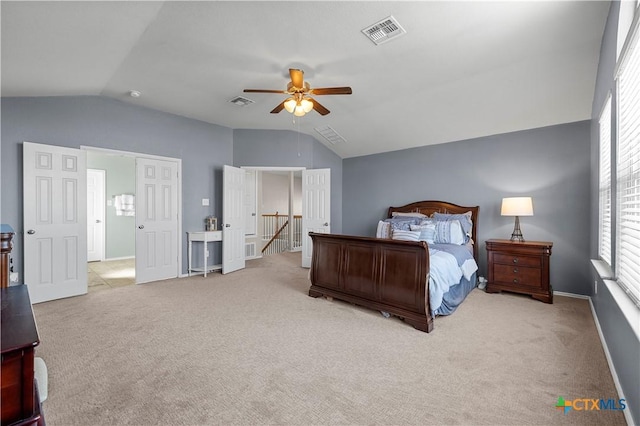 carpeted bedroom featuring lofted ceiling, baseboards, visible vents, and a ceiling fan