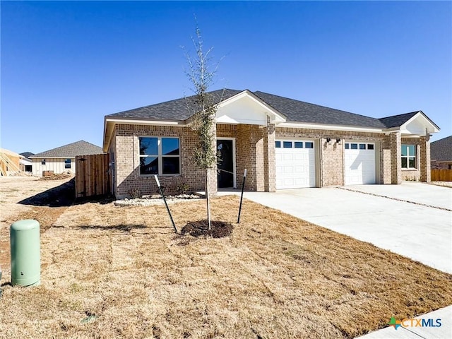 single story home with fence, roof with shingles, concrete driveway, a garage, and brick siding