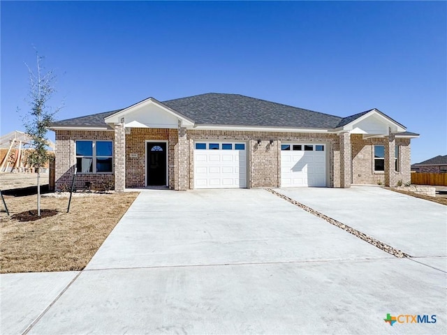 ranch-style house featuring brick siding, a shingled roof, fence, driveway, and an attached garage