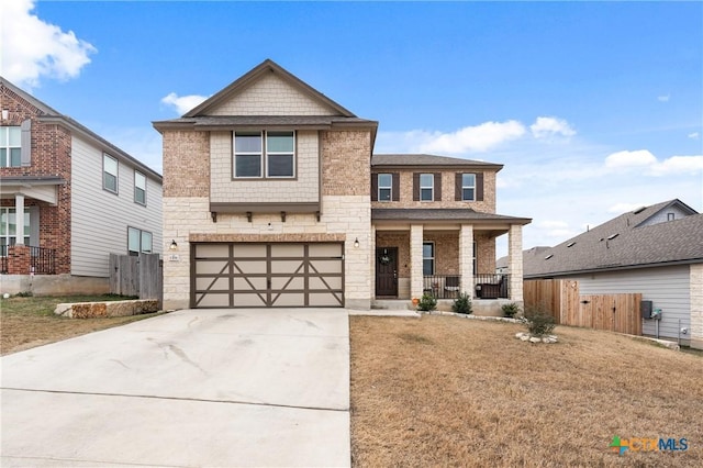 view of front of house with a garage, a front lawn, and a porch