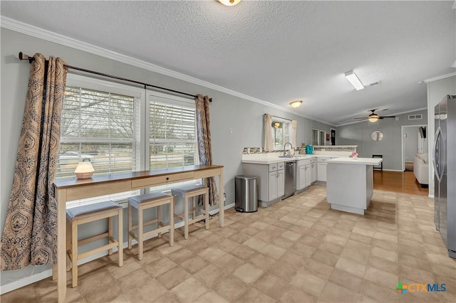 kitchen featuring ornamental molding, appliances with stainless steel finishes, sink, and kitchen peninsula