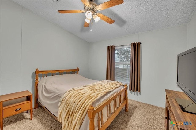 bedroom featuring ceiling fan, light colored carpet, and a textured ceiling