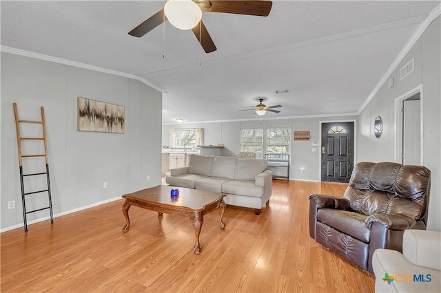 living room featuring crown molding, ceiling fan, and light hardwood / wood-style flooring