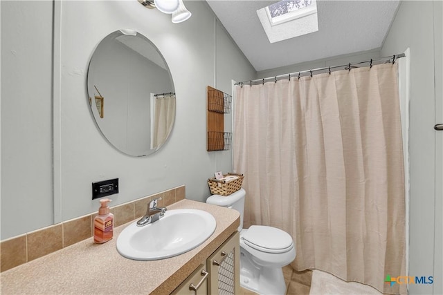 bathroom featuring vanity, a skylight, tile patterned floors, and toilet