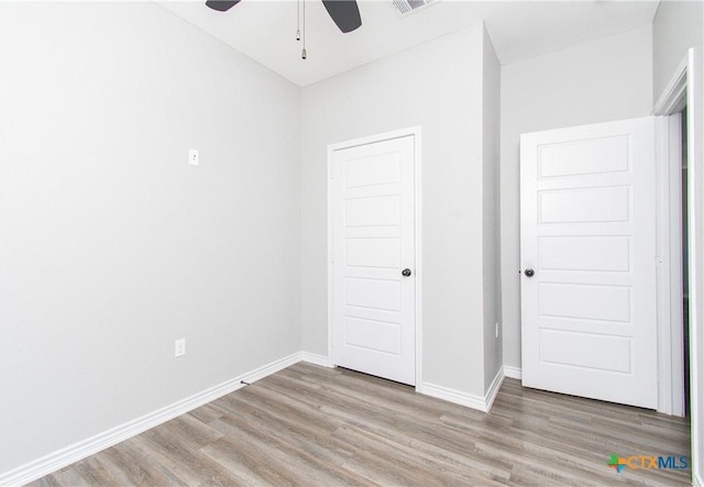 unfurnished bedroom featuring hardwood / wood-style flooring and ceiling fan