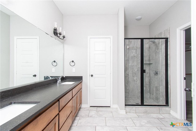 bathroom featuring vanity and a shower with shower door