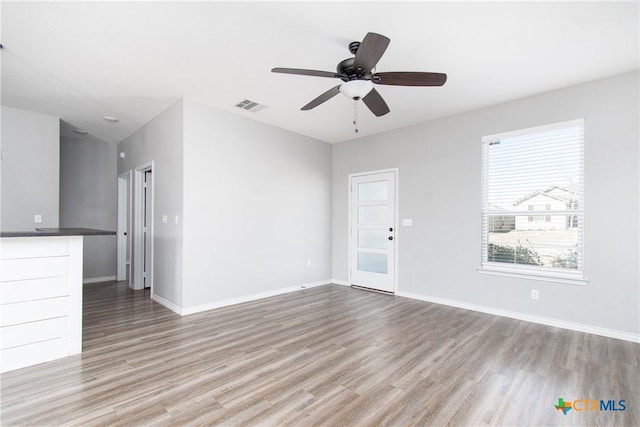 spare room with light hardwood / wood-style flooring and ceiling fan