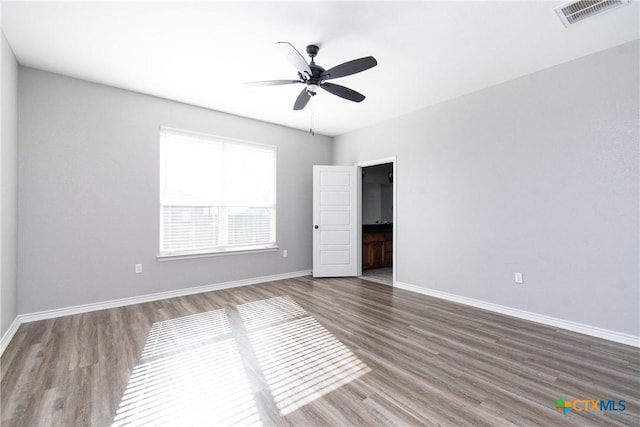 empty room featuring wood-type flooring and ceiling fan