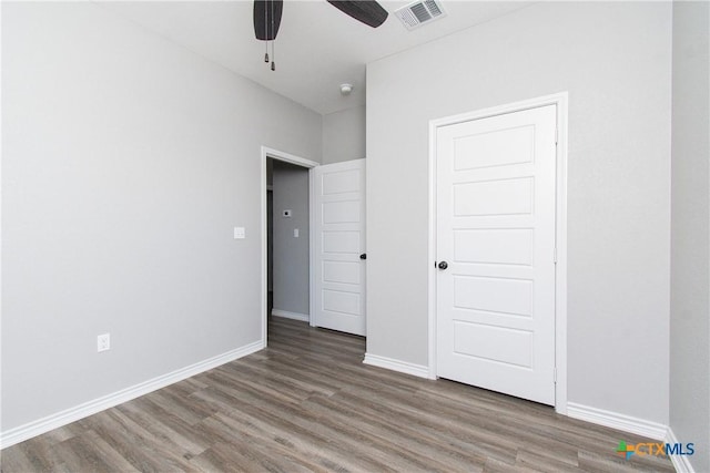 unfurnished bedroom with hardwood / wood-style flooring and ceiling fan