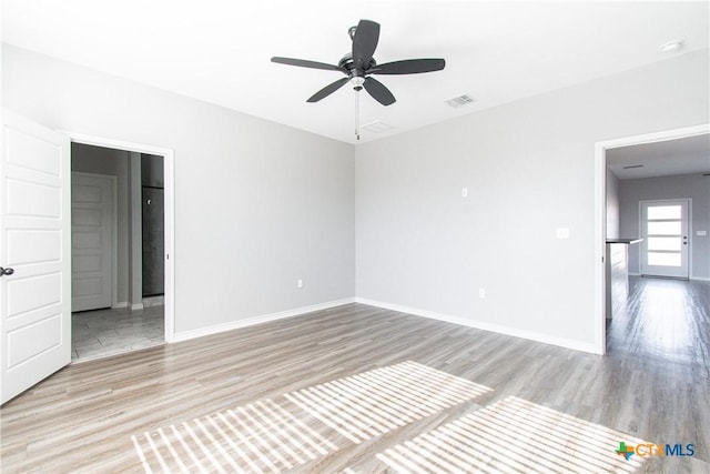 empty room featuring ceiling fan and light wood-type flooring