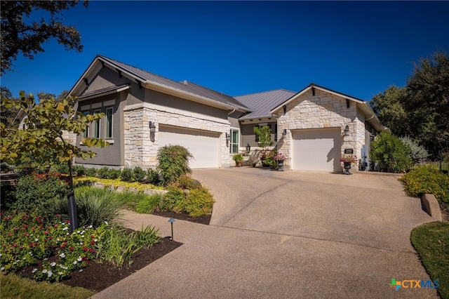 2319 Geneseo Oaks, New Braunfels, TX 78132 - view of front of property with concrete driveway, metal roof, stone siding, an attached garage, and a standing seam roof