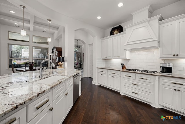 2319 Geneseo Oaks, New Braunfels, TX 78132 - kitchen with dark wood-type flooring, a sink, tasteful backsplash, appliances with stainless steel finishes, and light stone countertops