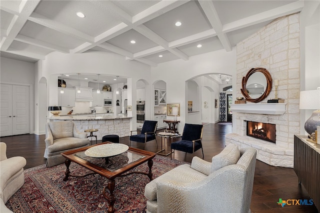 2319 Geneseo Oaks, New Braunfels, TX 78132 - living area with arched walkways, coffered ceiling, a towering ceiling, and dark wood-style flooring