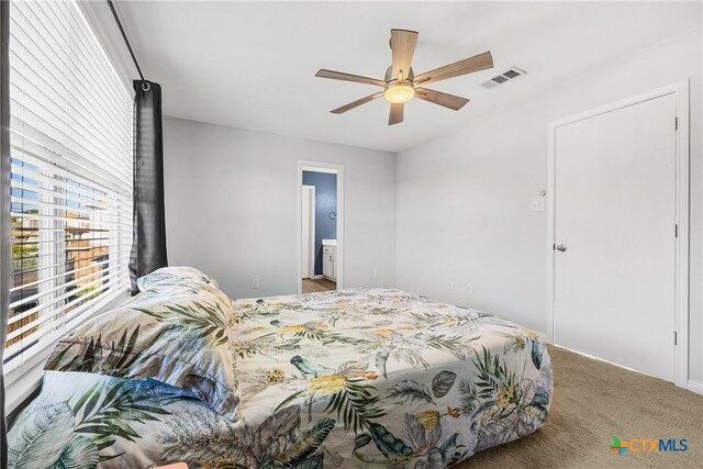 3410 Regency Ct, Killeen, TX 76549 - carpeted bedroom with connected bathroom and a ceiling fan