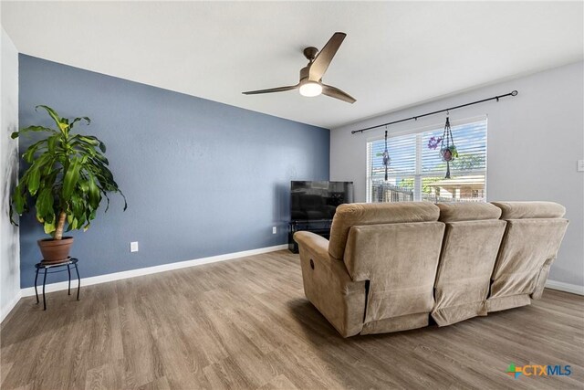 3410 Regency Ct, Killeen, TX 76549 - living area featuring a ceiling fan, wood finished floors, and baseboards