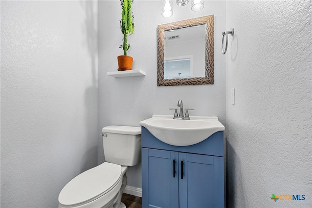3410 Regency Ct, Killeen, TX 76549 - half bathroom with vanity, toilet, and a textured wall