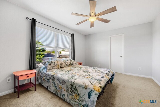 3410 Regency Ct, Killeen, TX 76549 - bedroom with light carpet, baseboards, and a ceiling fan