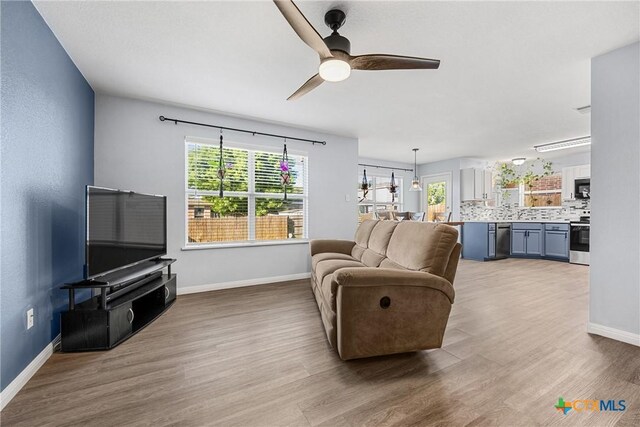 3410 Regency Ct, Killeen, TX 76549 - living room with wood finished floors, plenty of natural light, and a ceiling fan